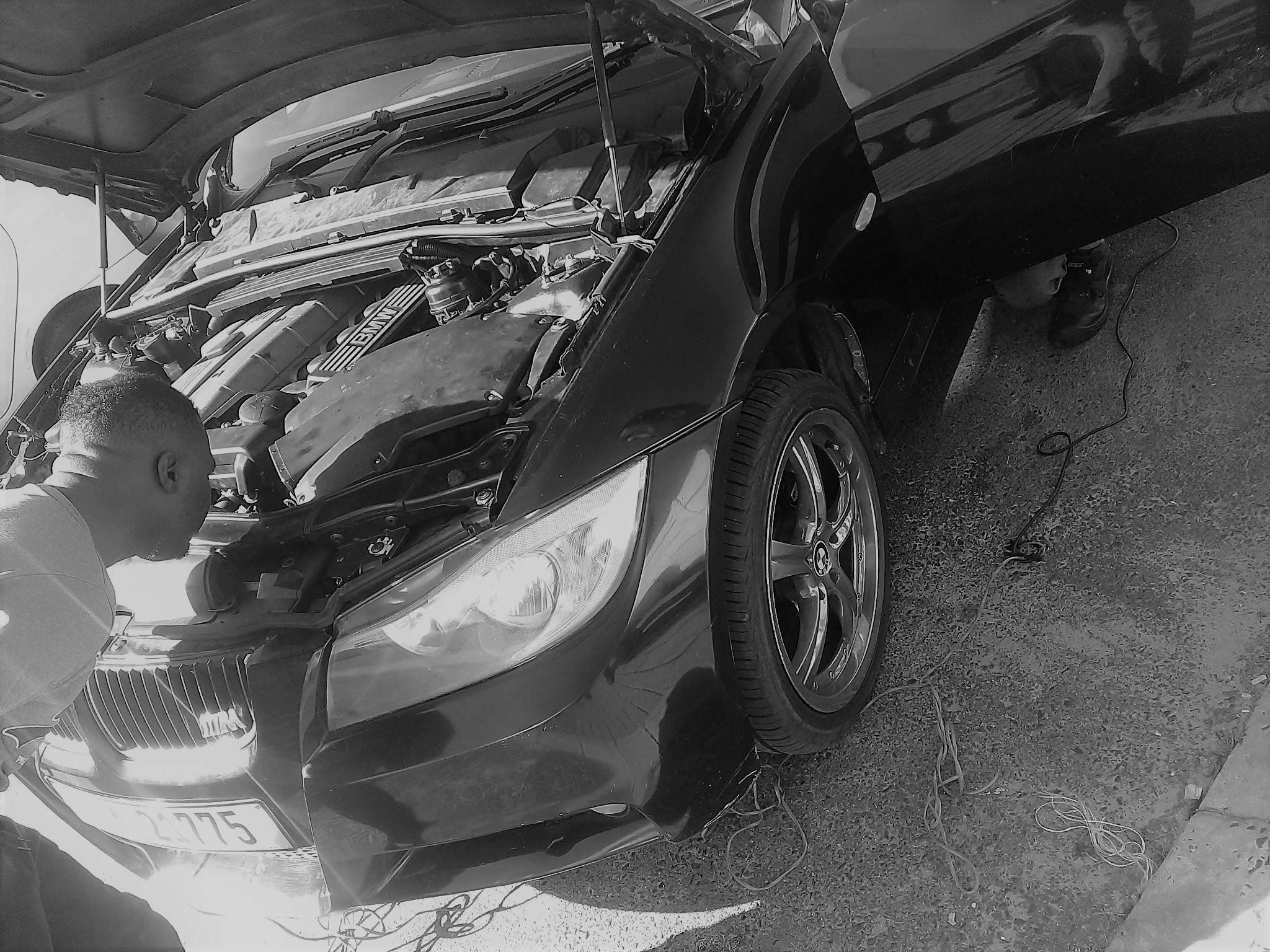 A Nico's Auto Repairs technician working on a BMW